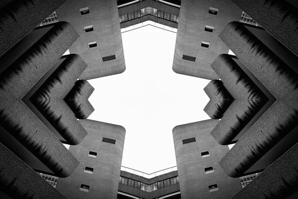 Brutalist concrete architecture looking up at sky