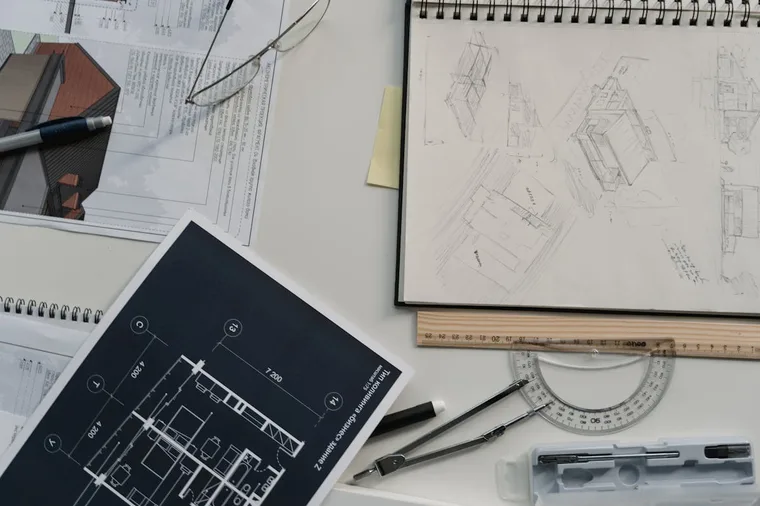 Architect workspace with blueprints, compass, and drafting tools