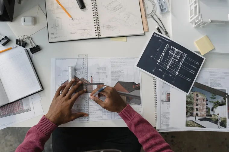 Architect working on design layouts at a desk