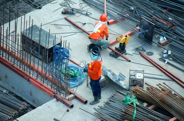 Architect and engineer reviewing plans at a construction site