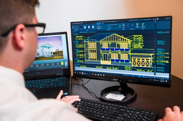 Architect working on 3D design software at a computer