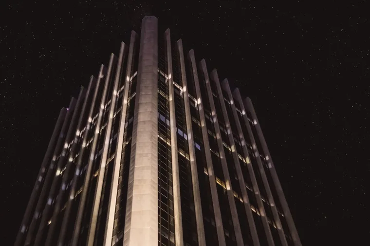 Glowing facade of a modern smart building illuminated at night