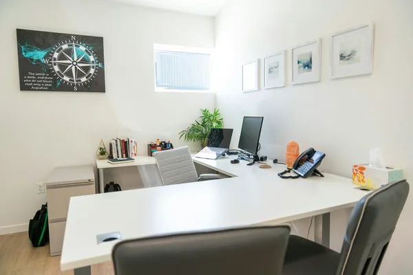 Modern office space with desk, computer, and decor