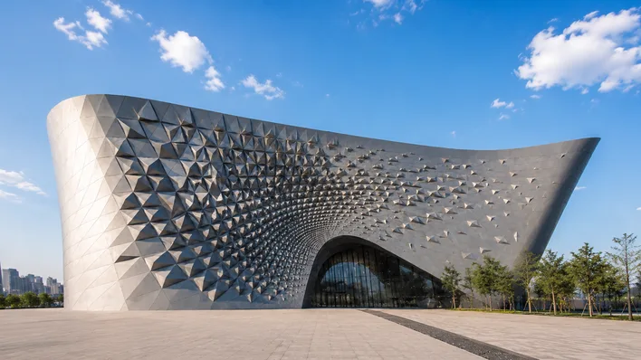 Curved building facade composed of thousands of adaptive parametric panels varying in size and rotation, the kind of complexity Grasshopper makes routine to design